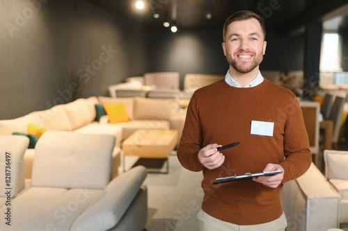 Behang Confident salesman standing in furniture store exhibition center