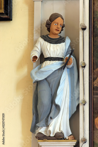 Saint Apollonia, statue on the altar of Saint Anthony the Great in the Church of the Assumption of the Virgin Mary in Novigrad na Dobri, Croatia photo