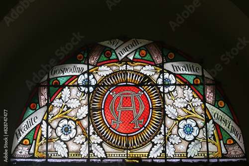 Alpha and Omega, stained glass window in the parish church of Saint Mary Magdalene in Prilisce, Croatia photo