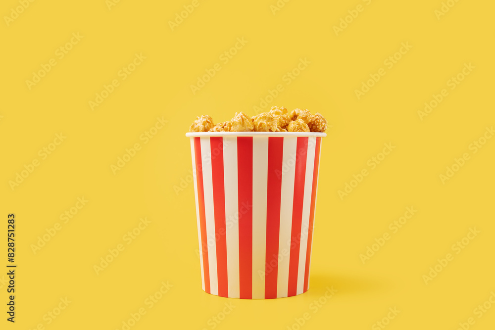 Popcorn box, sweet treat, cinema snack, yellow background