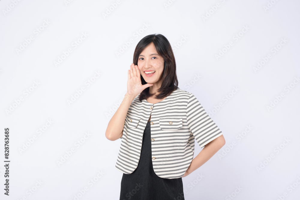 Asian woman is posing with a shouting gesture against a white background. Asian woman is posing with a shouting gesture against a white background.