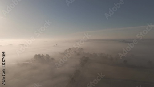 Above the Clouds: Aerial View of Friesland Farmland in Morning Mist (ID: 828774209)