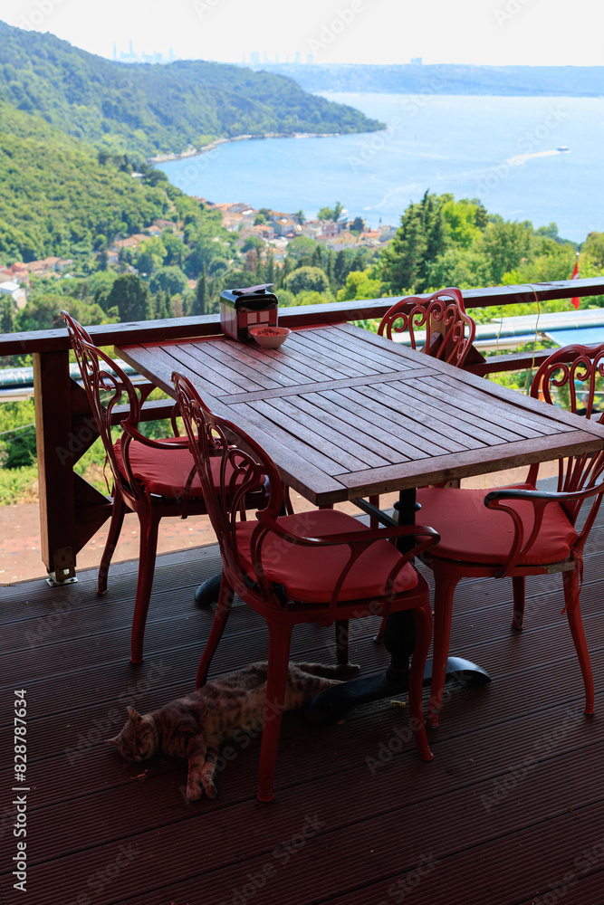 Fototapeta premium Beautiful views from above, tables in a cafe in the mountains and a panoramic view of the city, public places in Turkey, on a sunny summer day
