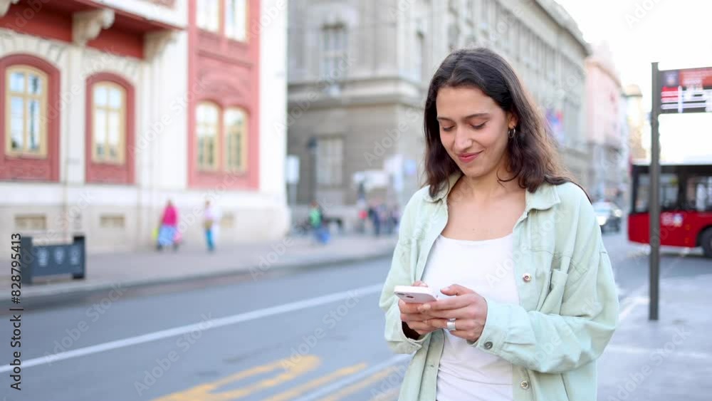 Happy girl texting on the move Happy girl texting on the move