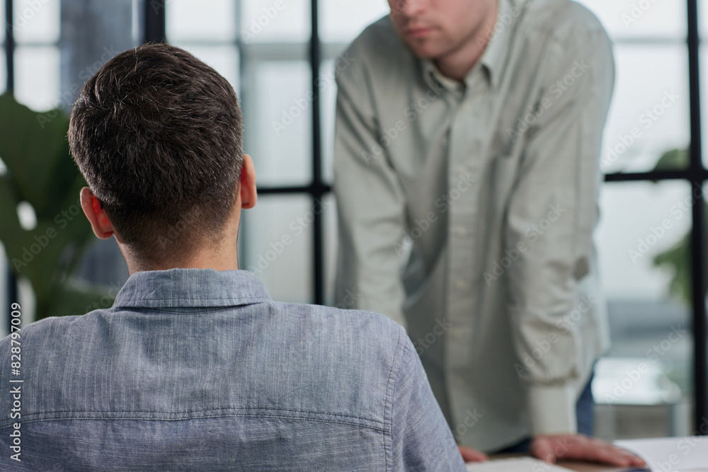 Fototapeta premium Mature businessman to discuss information with a younger colleague in a modern business lounge