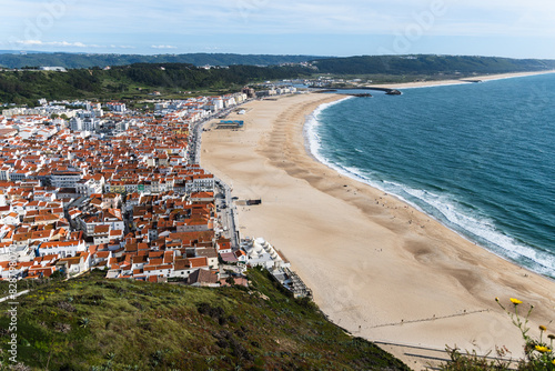 View from the hill to the sandy beach 'Praia da Nazaré' , Praia do Norte beach and Nazare town, Portugal © Diego