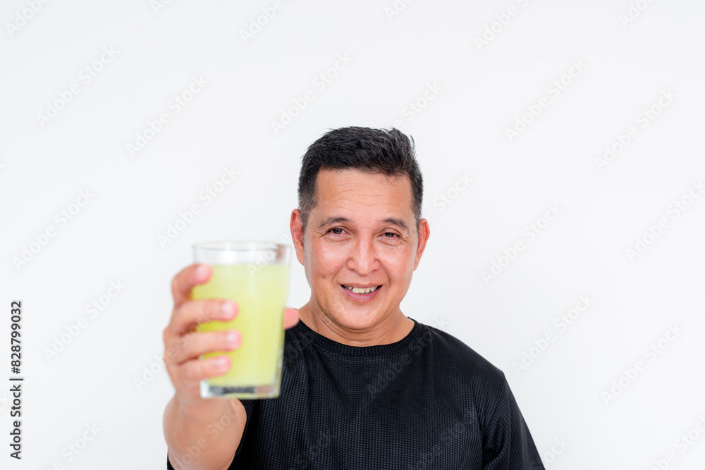 A cheerful middle aged Asian man smiles as he drinks a refreshing glass of lemonade, set against a white background. A cheerful middle aged Asian man smiles as he drinks a refreshing glass of lemonade, set against a white background.