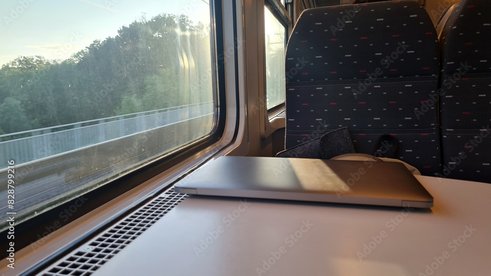 Working on the Go: Using a Laptop on a Train Journey with Scenic Views Outside the Window - Emphasizing Productive Travel and Efficient Transportation Working on the Go: Using a Laptop on a Train Journey with Scenic Views Outside the Window - Emphasizing Productive Travel and Efficient Transportation