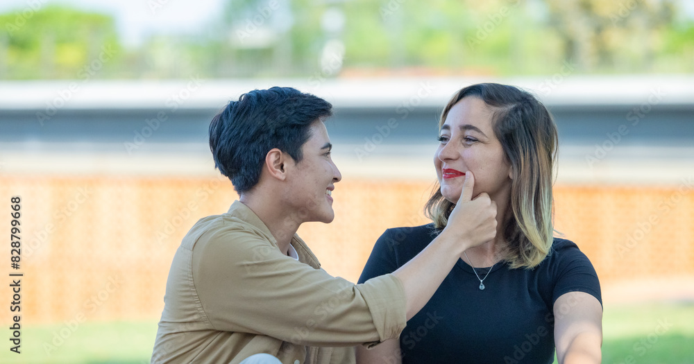 LGBT couple sharing romantic love and care in public, celebrating joyful union as life partners. LGBT couple sharing romantic love and care in public, celebrating joyful union as life partners.