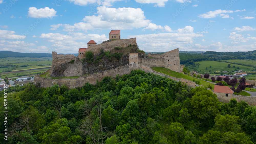 Rupea fortress in Romania. Amazing aerial view with blue sky with clouds. Trips to Transylvania. Rupea fortress in Romania. Amazing aerial view with blue sky with clouds. Trips to Transylvania.