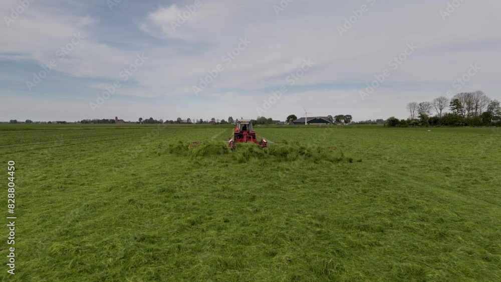 Harvesting Season: Aerial Shot of Tractor Shaking Grass on Farmland Harvesting Season: Aerial Shot of Tractor Shaking Grass on Farmland