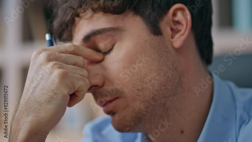 Businessman suffering eye strain overwork in office closeup. Tired man thinking