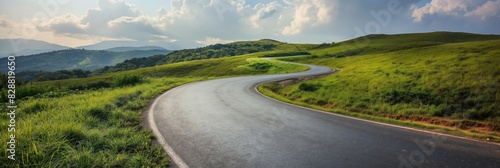 A scenic winding road stretching through vibrant green hills under a cloud-filled sky, perfect for travel themes