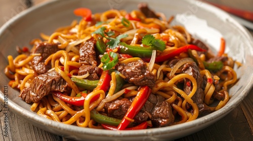 Asian stir-fried noodles with beef, peppers, and onions - delicious panoramic view of savory dish