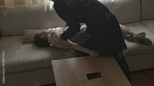 Man carrying unconscious woman in arms. Stock. Close-up of man carrying unconscious woman in arms. Man carries unconscious woman and puts her on sofa