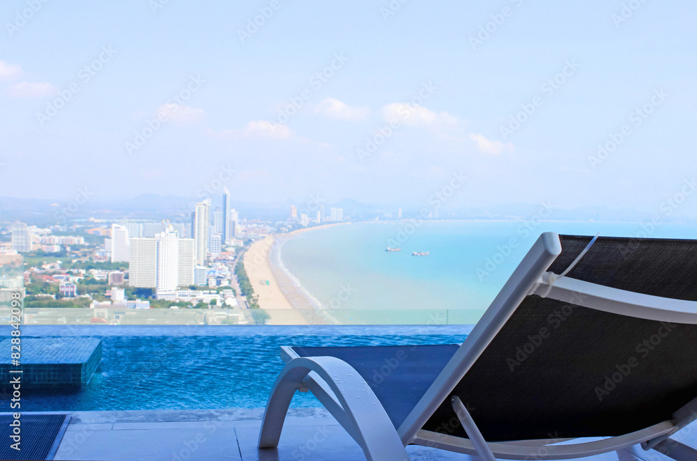 Fototapeta premium Enjoy the picturesque beach view while you unwind next to the pool at a luxurious hotel