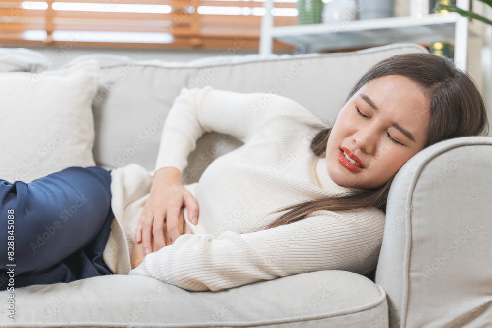 young woman gripping her stomach have abdominal pain . young woman gripping her stomach have abdominal pain .