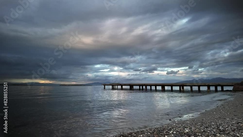 Wallpaper Mural A pier on the coast, with a cloudy sky and water stretching to the horizon. The afterglow of dusk reflects off the wind waves on the natural landscape Torontodigital.ca