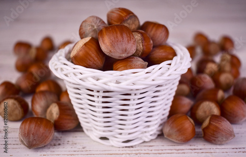 Hazelnuts in a white basket on a wooden background.Close-up.
