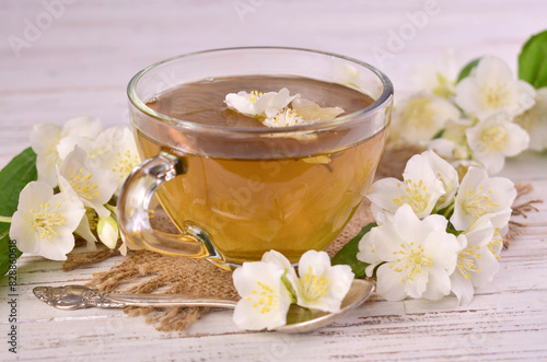 Fragrant tea with jasmine flowers in a transparent cup. Close-up.
