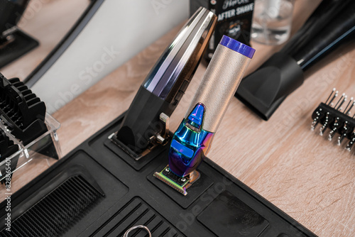 Hair clippers and trimmers are on the table in the barbershop photo