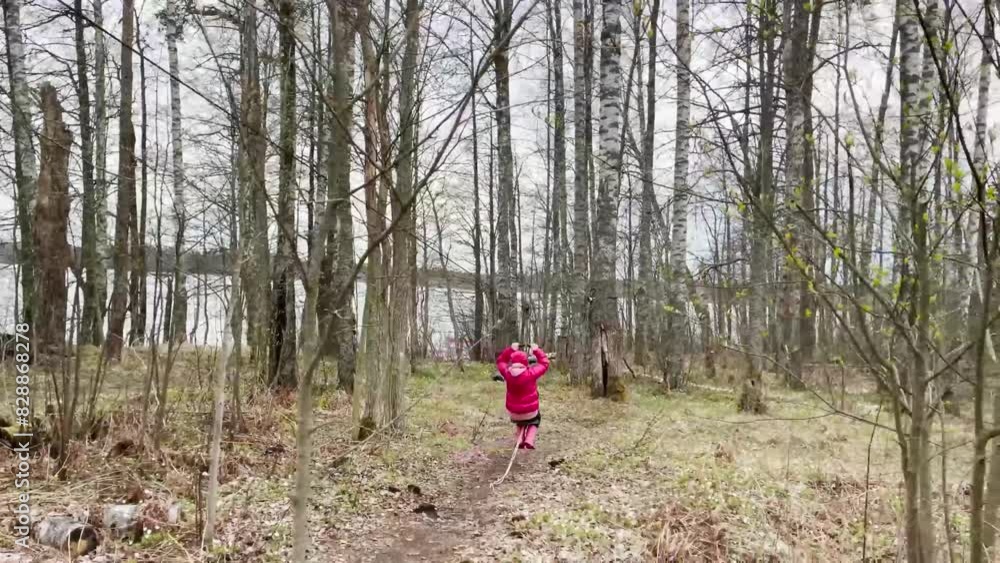 Little girl having fun outdoors. Zipline for kids. Little girl having fun outdoors. Zipline for kids.