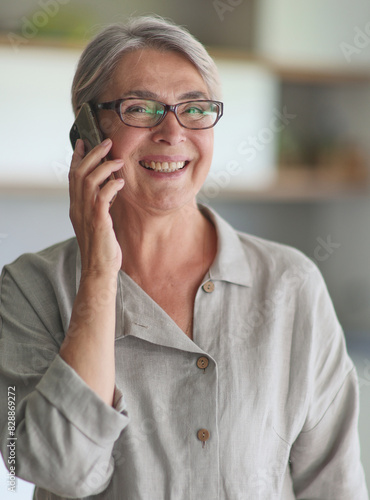 mature woman calling on the phone in the office