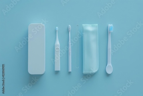 A compact travel sized oral hygiene kit including a toothbrush mini toothpaste and dental floss arranged on a simple bright surface