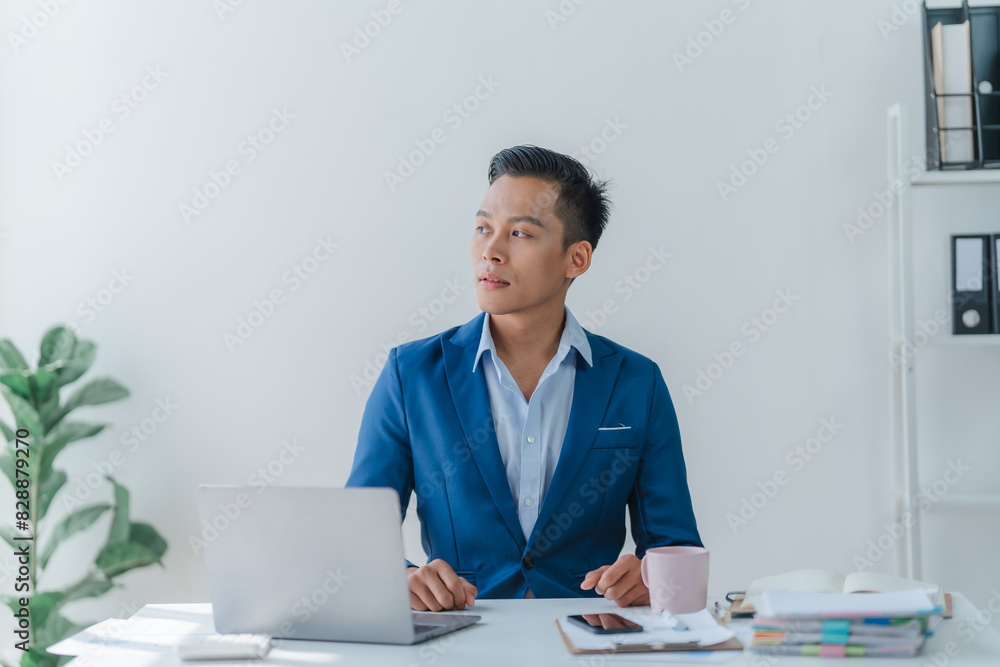 Asian business team discussing over laptop in a corporate. Group collaboration and teamwork concept. Asian business team discussing over laptop in a corporate. Group collaboration and teamwork concept.