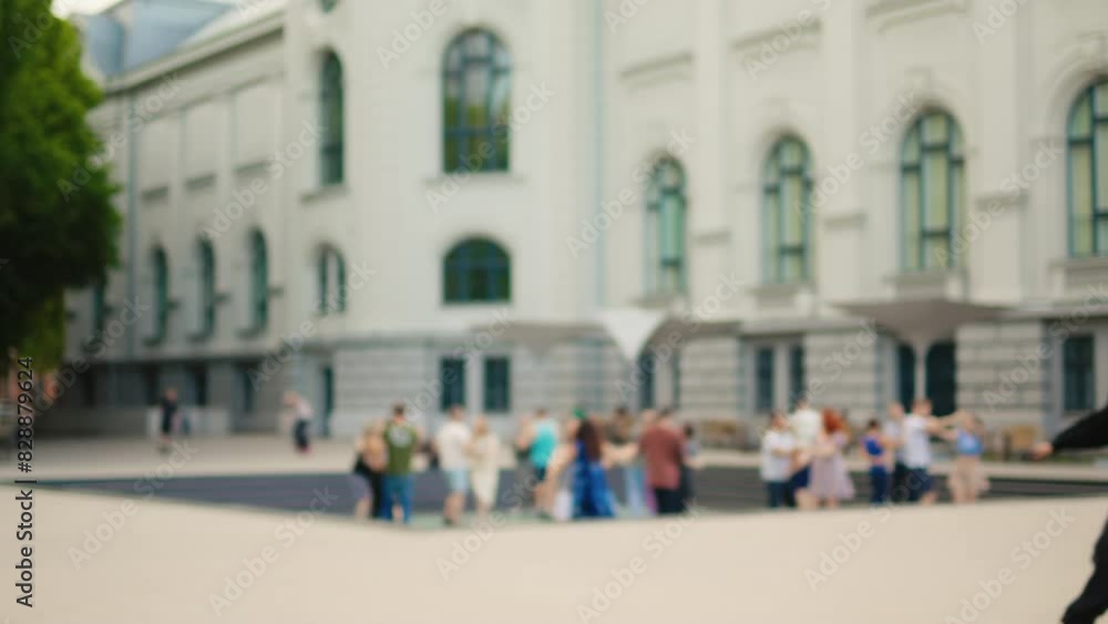 An urban event in front of a classical building, people enjoying the sunny day and socializing An urban event in front of a classical building, people enjoying the sunny day and socializing