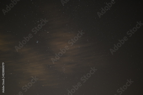 the moon and the stars shine in the night sky above an abandoned road