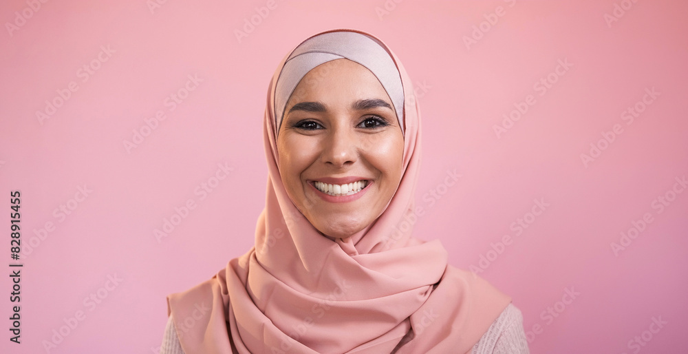 Happy muslim woman. Positive attitude. Traditional outfit. Portrait of joyful smiling female face in hijab isolated on pink empty space background. Happy muslim woman. Positive attitude. Traditional outfit. Portrait of joyful smiling female face in hijab isolated on pink empty space background.