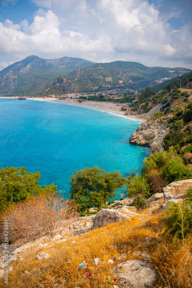 Fototapeta premium Aerial view of Oludeniz beach with people and boats in the morning, Coastline next to Fethiye, Turkey