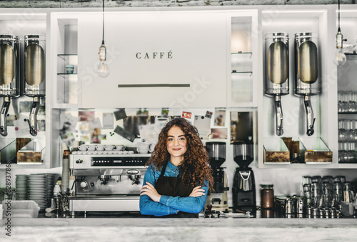 Fotografie Beautiful female barista working in coffee shop