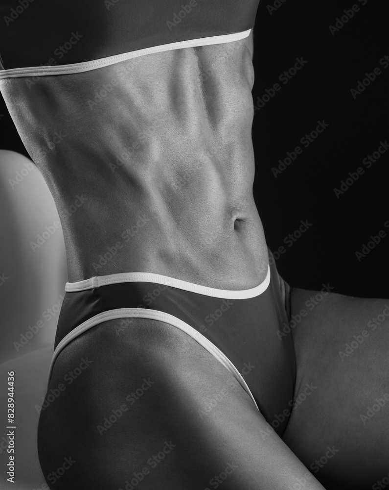 Naklejka premium A slender swarthy Bodybuilder girl in red sportswear on a white background. Healthy lifestyle, sport and diet.