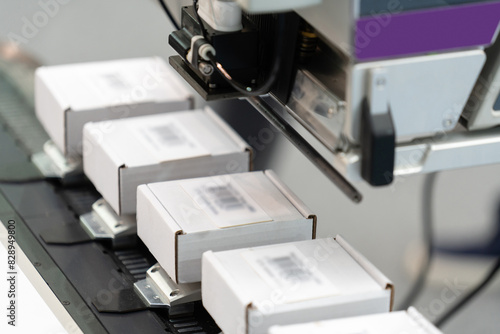 Картината върху платно Machine for labeling barcodes on boxes.