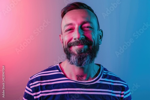 Handsome mature man in striped shirt shows tender smile. photo