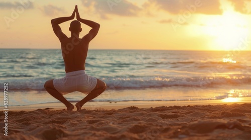 Man doing yoga on beach, sunrise, calm ocean, and sandy shore. Sunrise yoga on beach, man with calm ocean and sand. © Eez Studio