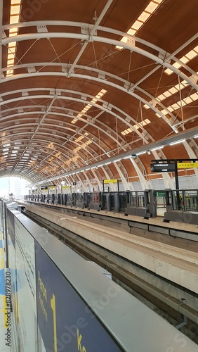 Jakarta, Indonesia – May 25, 2024: View of LRT Station Jakarta Dukuh Atas tunnel construction arch steel and railway from platform. photo