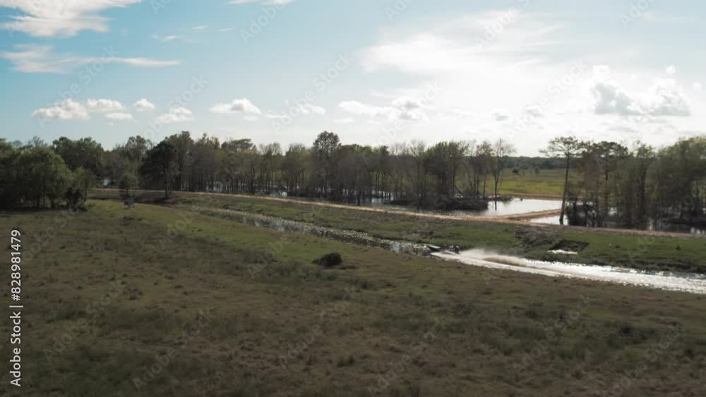 Aerial Panning Scenic Shot Motorboat Moving In River, Drone Ascending Over Green Landscape On Sunny Day - Bayou Vista, Texas Aerial Panning Scenic Shot Motorboat Moving In River, Drone Ascending Over Green Landscape On Sunny Day - Bayou Vista, Texas