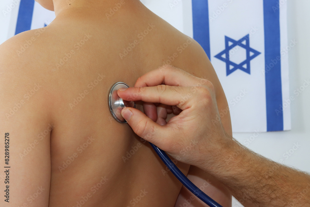 Fototapeta premium Pediatric medicine in Israel - doctor listening to child with stethoscope