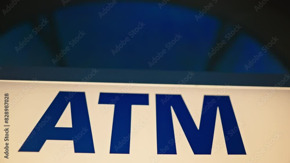 An illuminated ATM bank machine in a city at night, offering convenient financial services all day An illuminated ATM bank machine in a city at night, offering convenient financial services all day