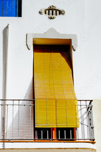 Urban Balcony with Yellow Blind on a Sunny Day