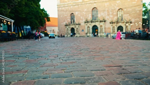 Explore an old European cobblestone street with historic charm and ancient buildings for visitors photo