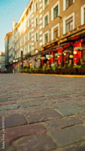 A charming cobblestone street with a cozy cafe ambiance is a perfect setting to enjoy the sunset photo