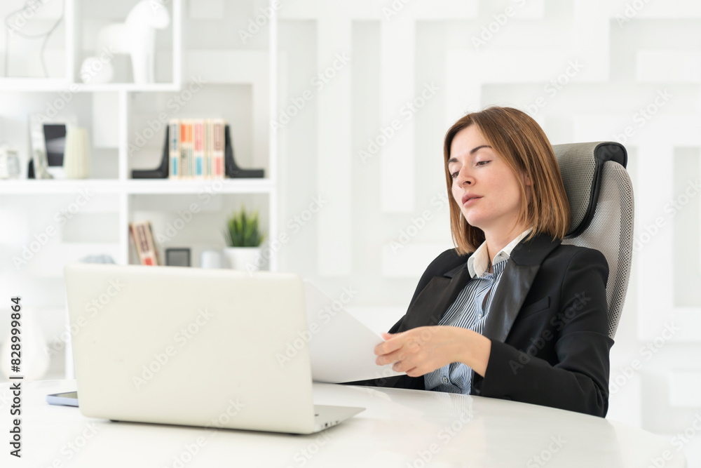 Serious business woman in black suit working in modern office Serious business woman in black suit working in modern office