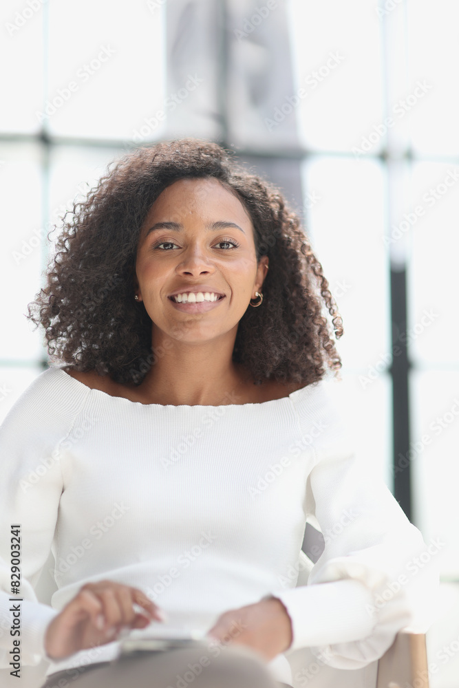 Portrait of a young attractive African American woman using a smartphone Portrait of a young attractive African American woman using a smartphone