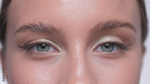 Beautiful woman with long eyelashes, beautiful make-up and thick eyebrows. Professional makeup and cosmetology skin care.