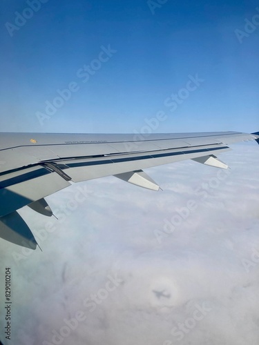 view from airplane window with shadow of airplane