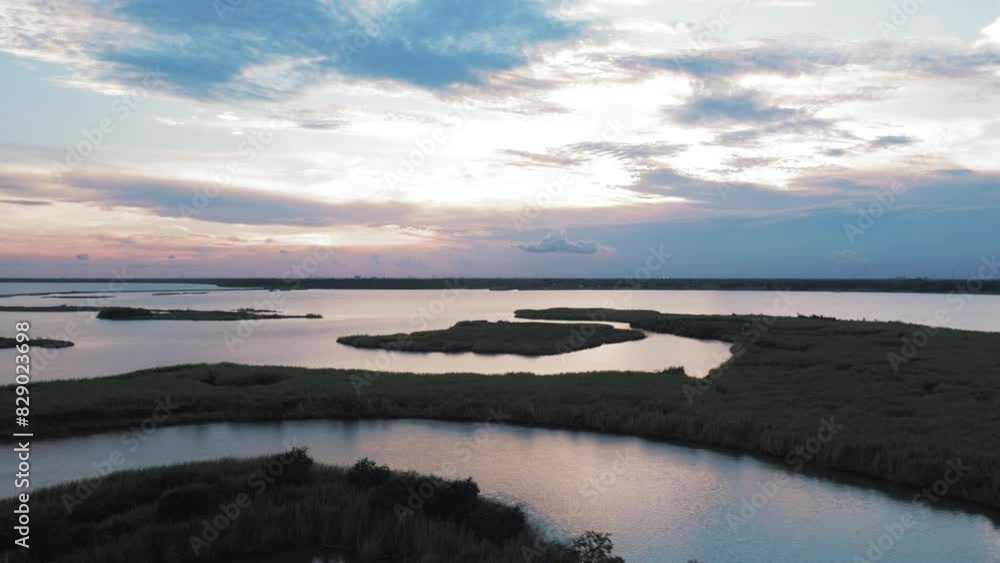 Aerial Forward Beautiful Shot Of Landscapes On Rippled River Under Cloudy Sky During Sunset - Bayou Vista, Texas Aerial Forward Beautiful Shot Of Landscapes On Rippled River Under Cloudy Sky During Sunset - Bayou Vista, Texas
